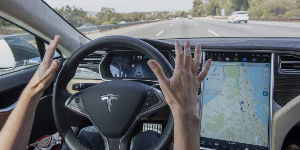 A member of the media test drives a Tesla Motors Inc. Model S car equipped with Autopilot in Palo Alto, California, U.S., on Wednesday, Oct. 14, 2015. Tesla Motors Inc. will begin rolling out the first version of its highly anticipated "autopilot" features to owners of its all-electric Model S sedan Thursday. Autopilot is a step toward the vision of autonomous or self-driving cars, and includes features like automatic lane changing and the ability of the Model S to parallel park for you. Photographer: David Paul Morris/Bloomberg via Getty Images